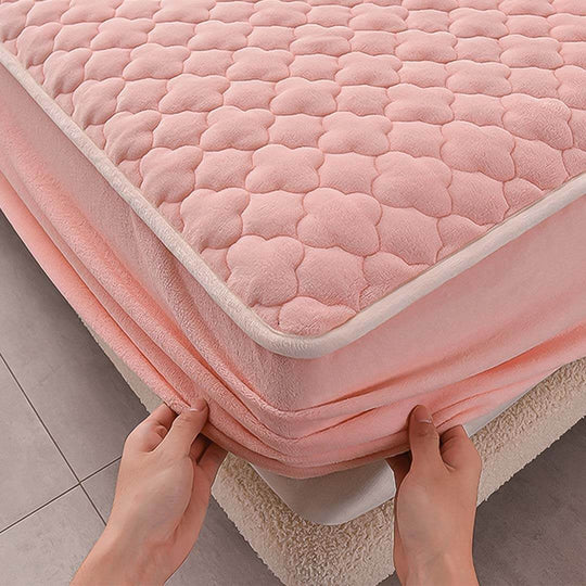 Soft pink mattress topper being adjusted by hands for comfort and support, showcasing affordable quality homewares and value furniture.