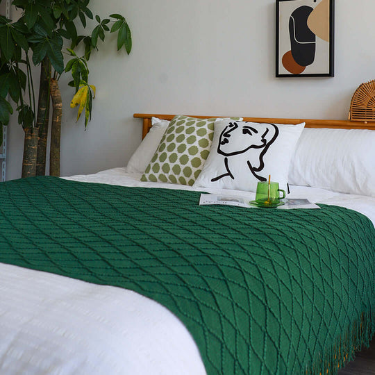 Modern bedroom with green patterned blanket, quality pillows, minimalist artwork, and affordable homewares. Value furniture completes the cozy setup.