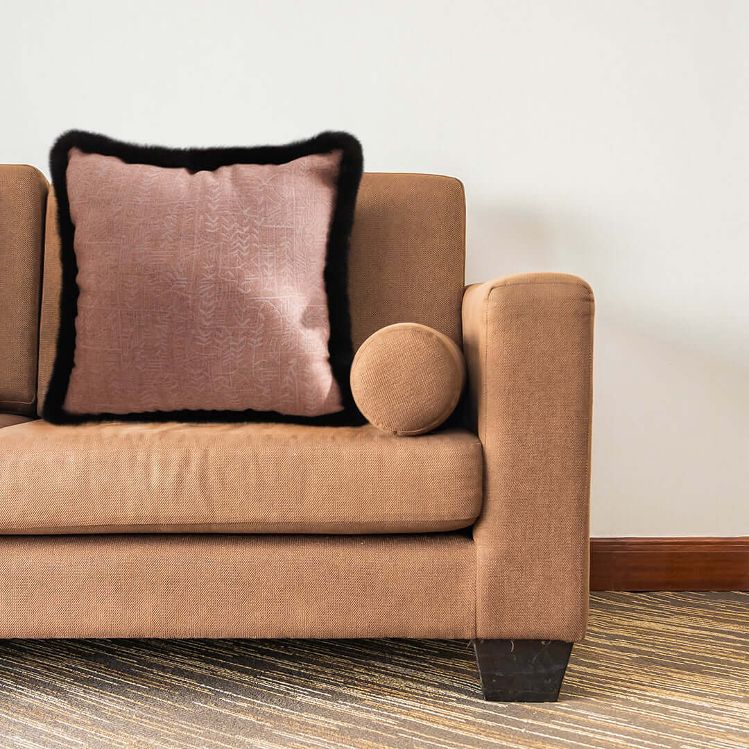 Affordable quality homewares and value furniture featuring a stylish brown sofa with a pink cushion and a matching bolster pillow.