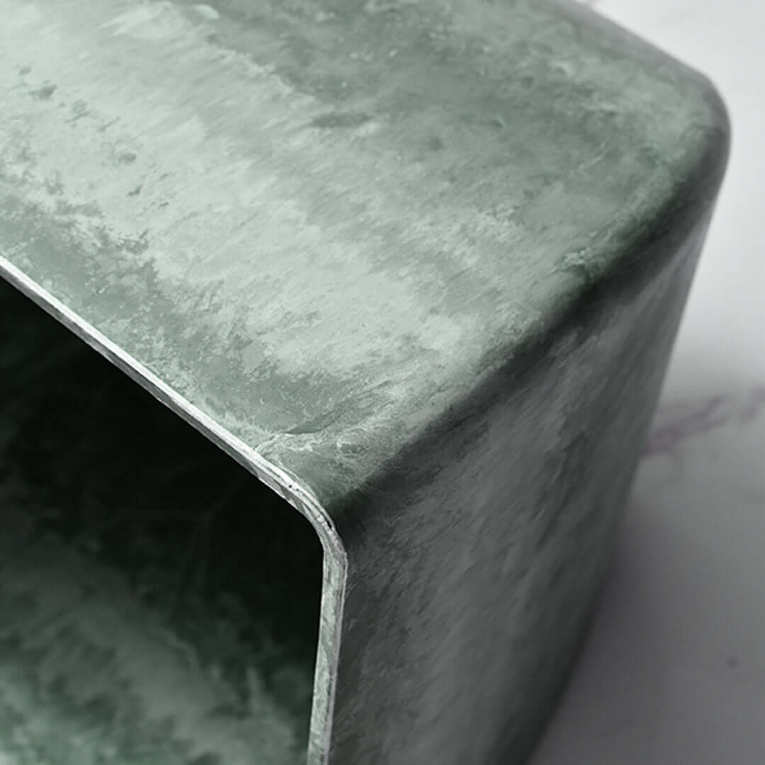 Affordable quality homewares - close-up of value furniture with green textured finish.