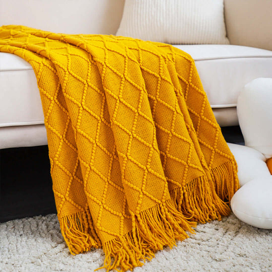 Affordable quality yellow knitted throw blanket on sofa, showcasing value furniture and stylish homewares