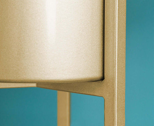 Close-up of quality value furniture leg and base with a modern design, showcasing the affordable homewares style against a teal background.