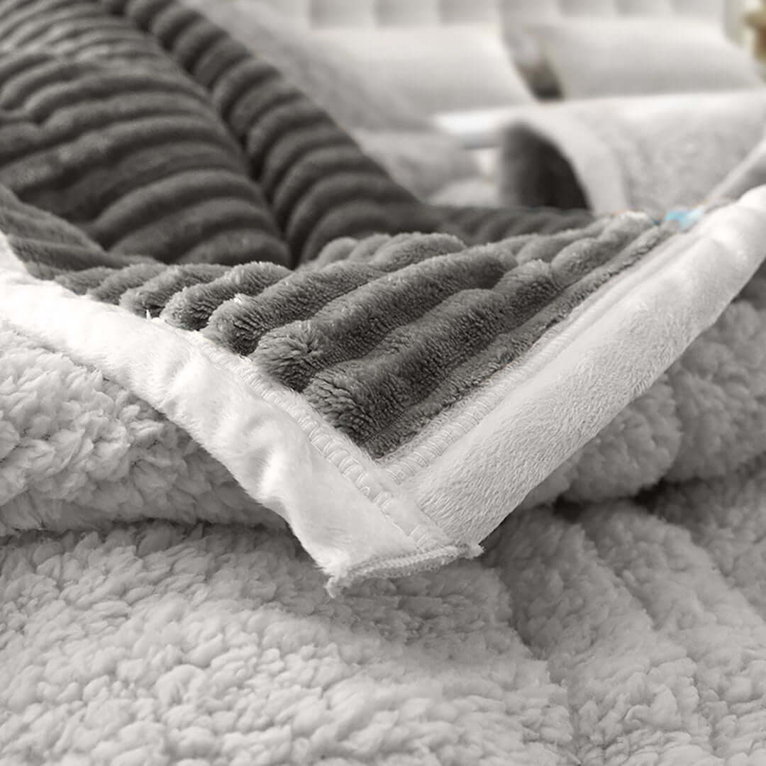 Luxurious gray textured blanket on a cozy bed, showcasing affordable and high-quality homewares for value furniture.