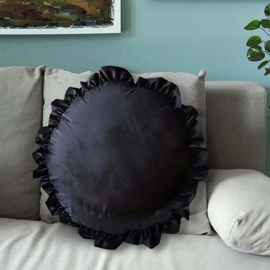 Affordable quality black ruffled round cushion on a light grey sofa, highlighting value furniture and stylish homewares for modern living.