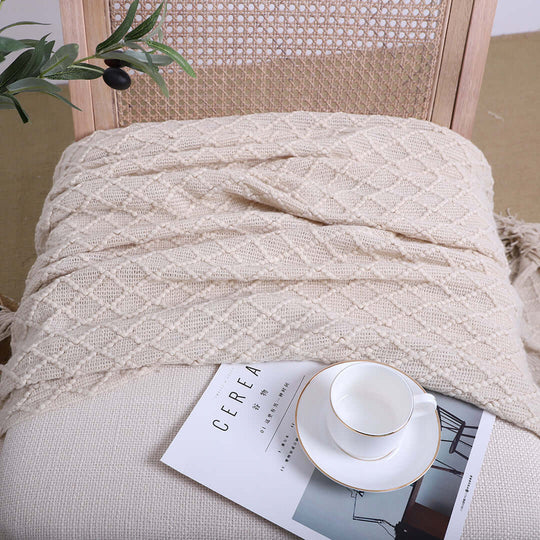 Cozy knit throw on chair with elegant cup and saucer, showcasing affordable quality homewares and value furniture.