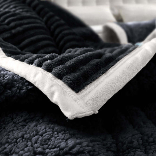 Affordable quality homewares featuring a soft and luxurious dark grey blanket with a white trim, representing value furniture enhancements.