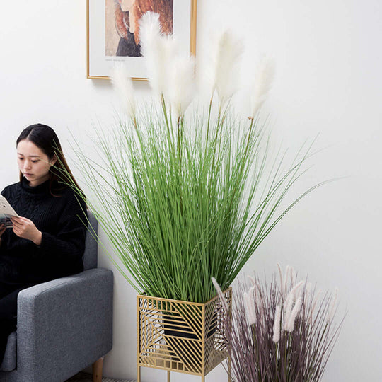 Woman sitting next to elegant affordable homeware, including a quality plant stand, showcasing stylish and value furniture options