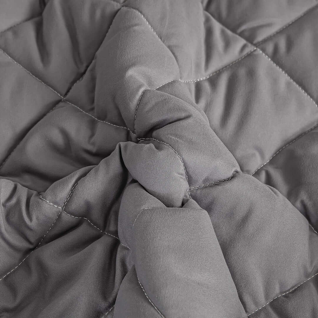 Quality affordable homewares - close-up of detailed stitching on a grey quilted fabric showcasing value furniture.