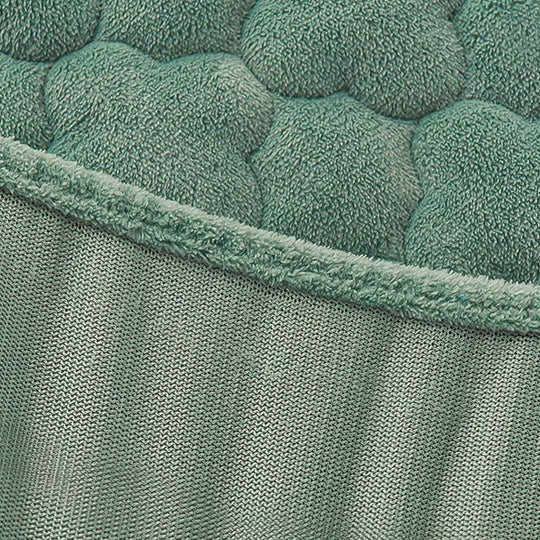 Affordable quality homeware - green textured fabric close-up for value furniture.