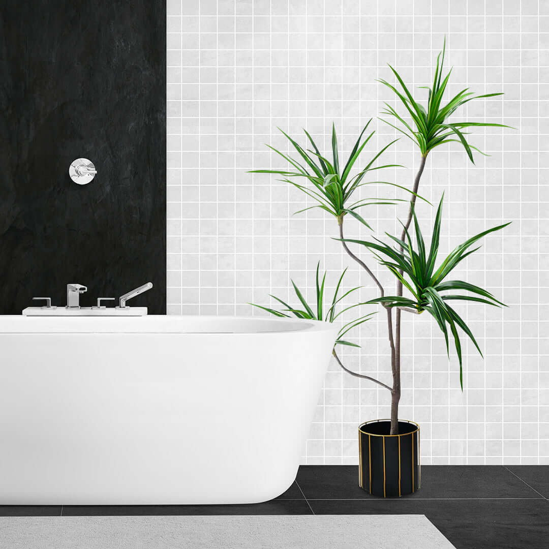 Modern white bathroom with bathtub and stylish indoor plant in decorative pot