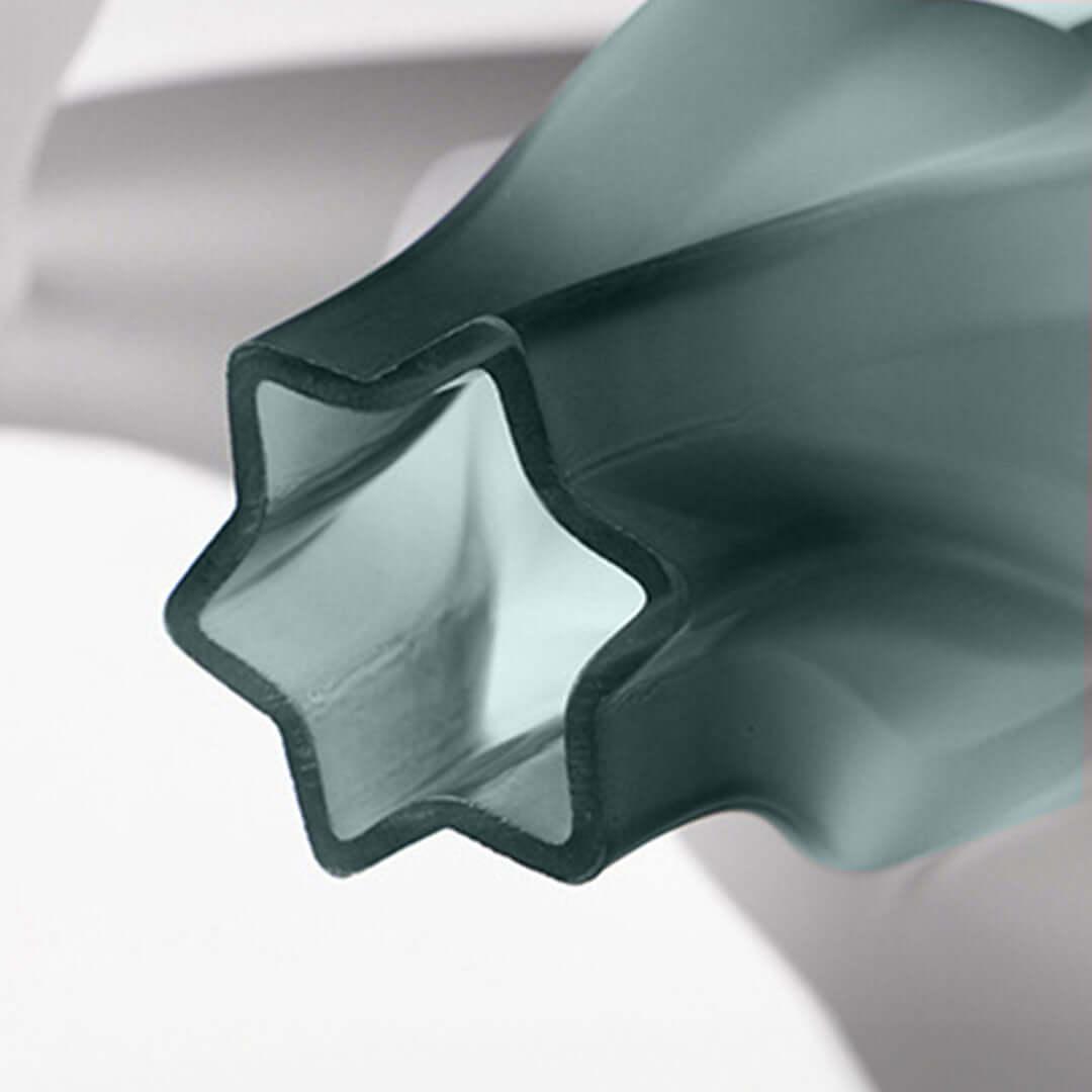 Close-up of a green, star-shaped, translucent affordable homeware vase reflecting quality and value furniture.