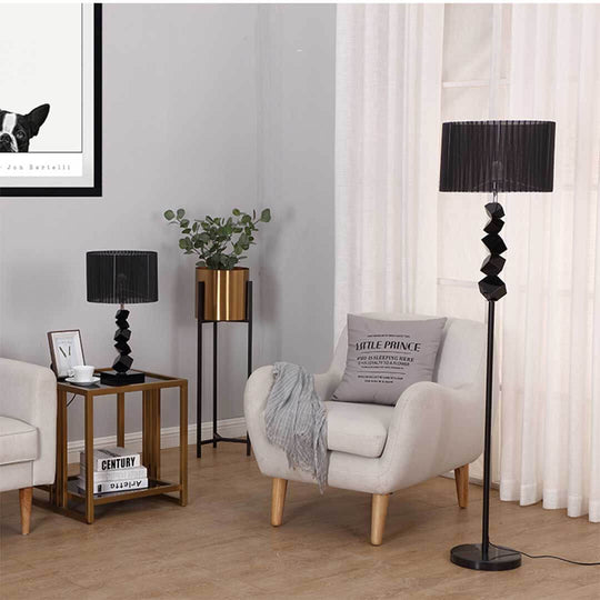 Modern living room with affordable quality homewares featuring a stylish armchair, value furniture, black lamps, and elegant decor.