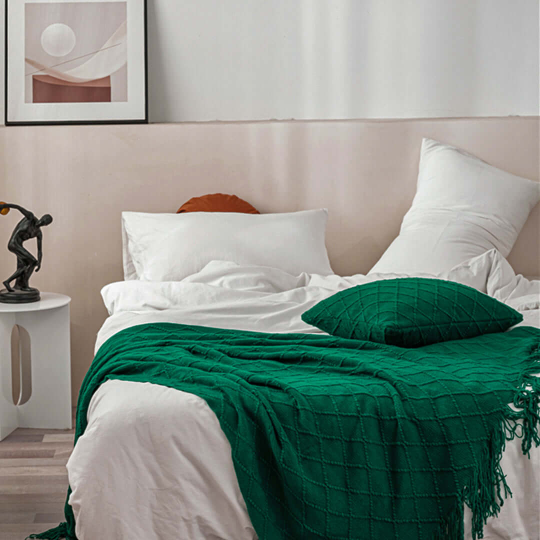 Stylish bedroom with affordable homewares, quality value furniture, and a cozy bed with green blanket and pillow