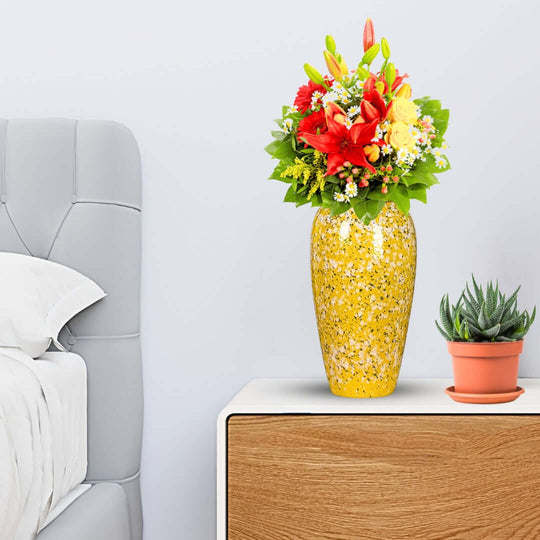 Colorful flower arrangement in yellow vase on modern nightstand with succulent plant, showcasing affordable homewares and quality value furniture.