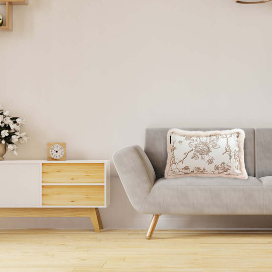 Affordable quality homewares and value furniture - cozy grey sofa with floral pillow and a modern wooden cabinet in a minimalist living room.