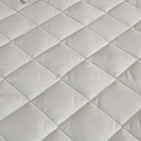 Quilted white mattress surface showcasing affordable quality homewares for value furniture.