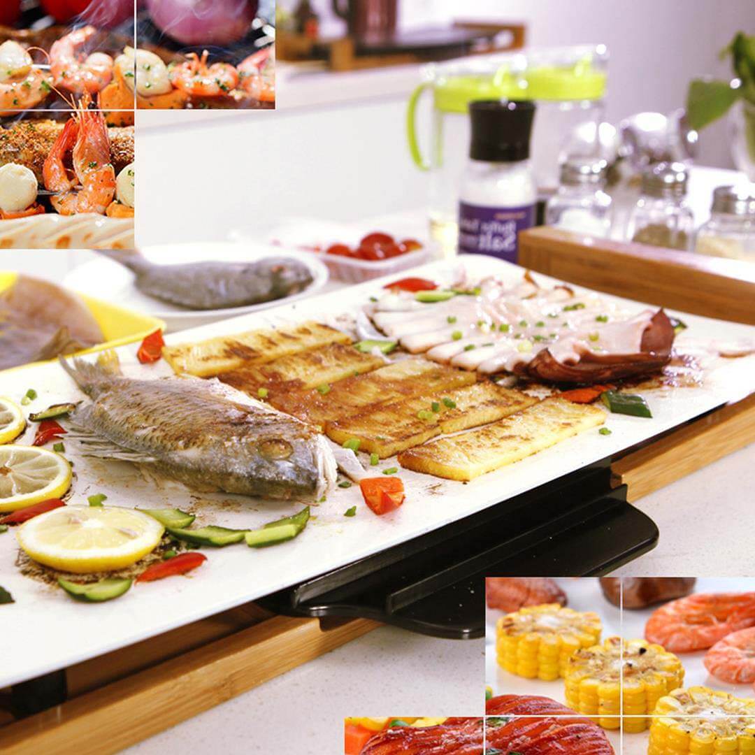 Grilled seafood and vegetables on a kitchen counter with spices and seasonings in the background.