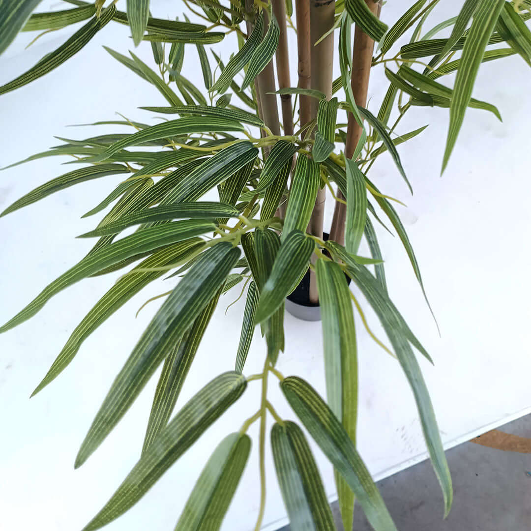 Lifelike artificial bamboo plant showcasing green leaves, ideal for adding a touch of nature to your affordable homewares collection.