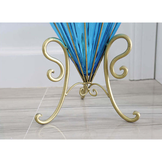 Gold metal stand holding a blue glass vase with intricate design, showcasing affordable quality homewares and value furniture.