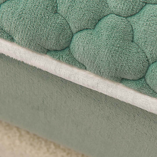 Affordable quality homewares - close-up of value furniture with green textured fabric.