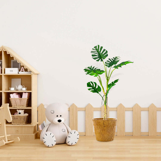 Affordable quality homewares and value furniture in a cozy kids' corner with a toy shelf, plush bear, and potted plant.