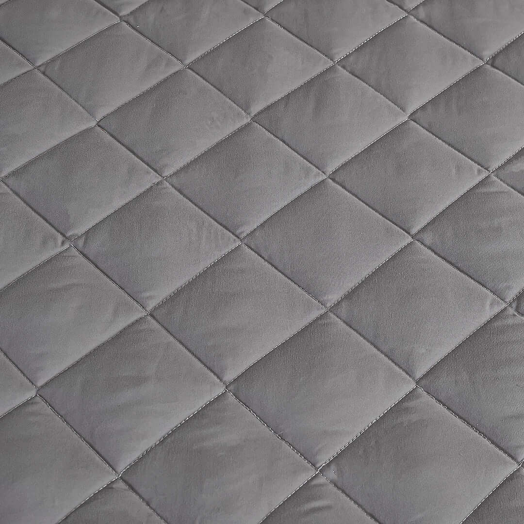 High-quality affordable quilted homeware, showcasing value furniture texture in gray tones.