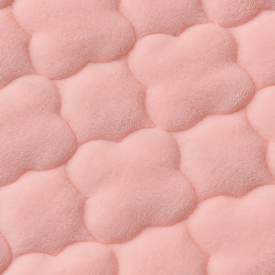 Close-up of soft pink textured fabric in cloud shapes, representing affordable quality homewares and value furniture.