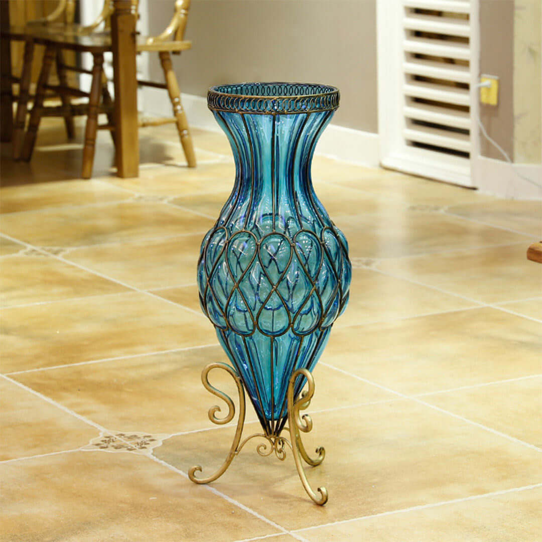 Blue decorative vase on ornate metallic stand in a modern home interior, showcasing affordable quality homewares and value furniture.