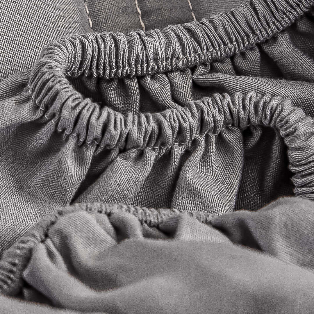 Close-up of grey fitted bed sheet showcasing quality fabric and affordable homewares for value furniture.