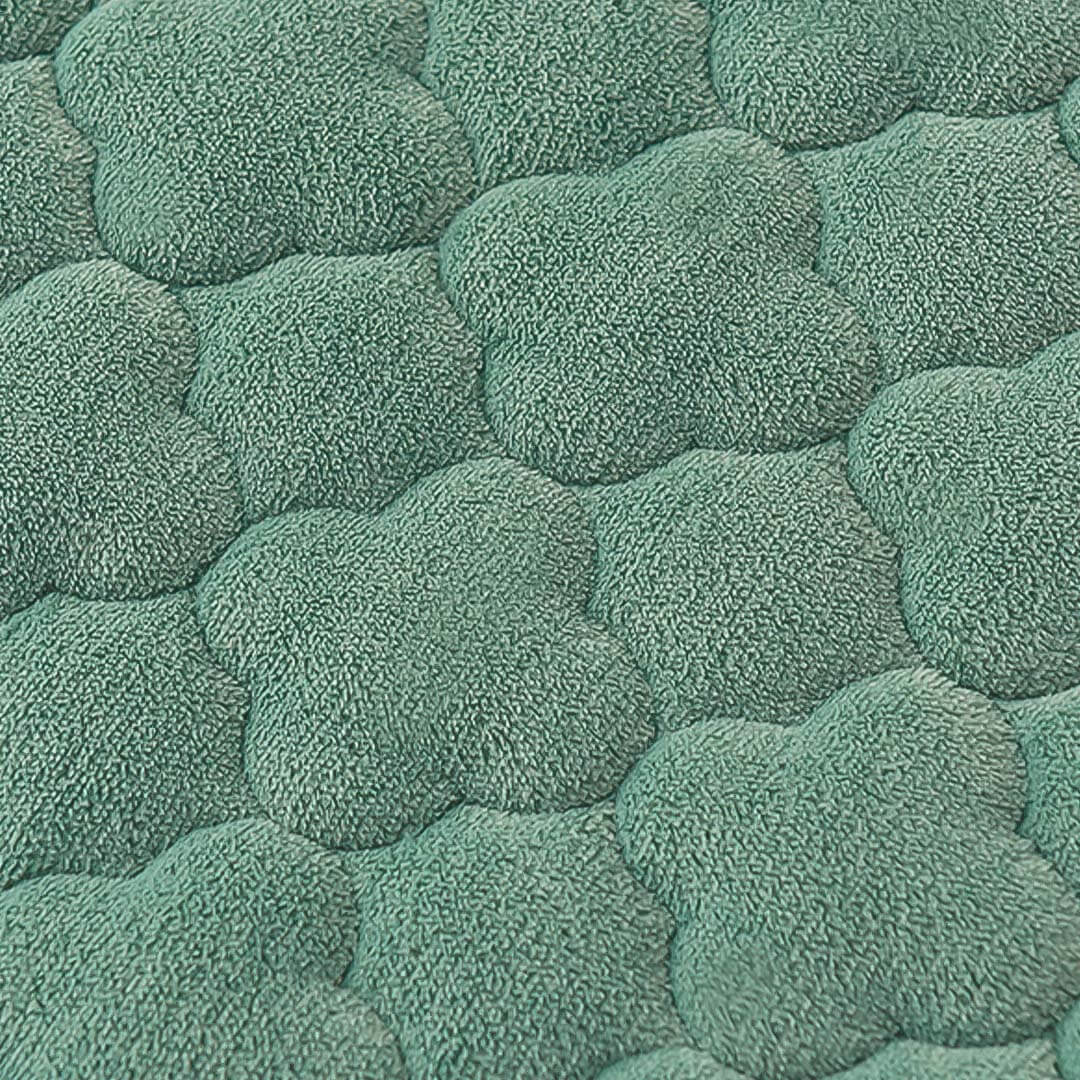 Green textured fabric with a soft, quilted pattern resembling overlapping flower petals, perfect for quality homewares and affordable value furniture.