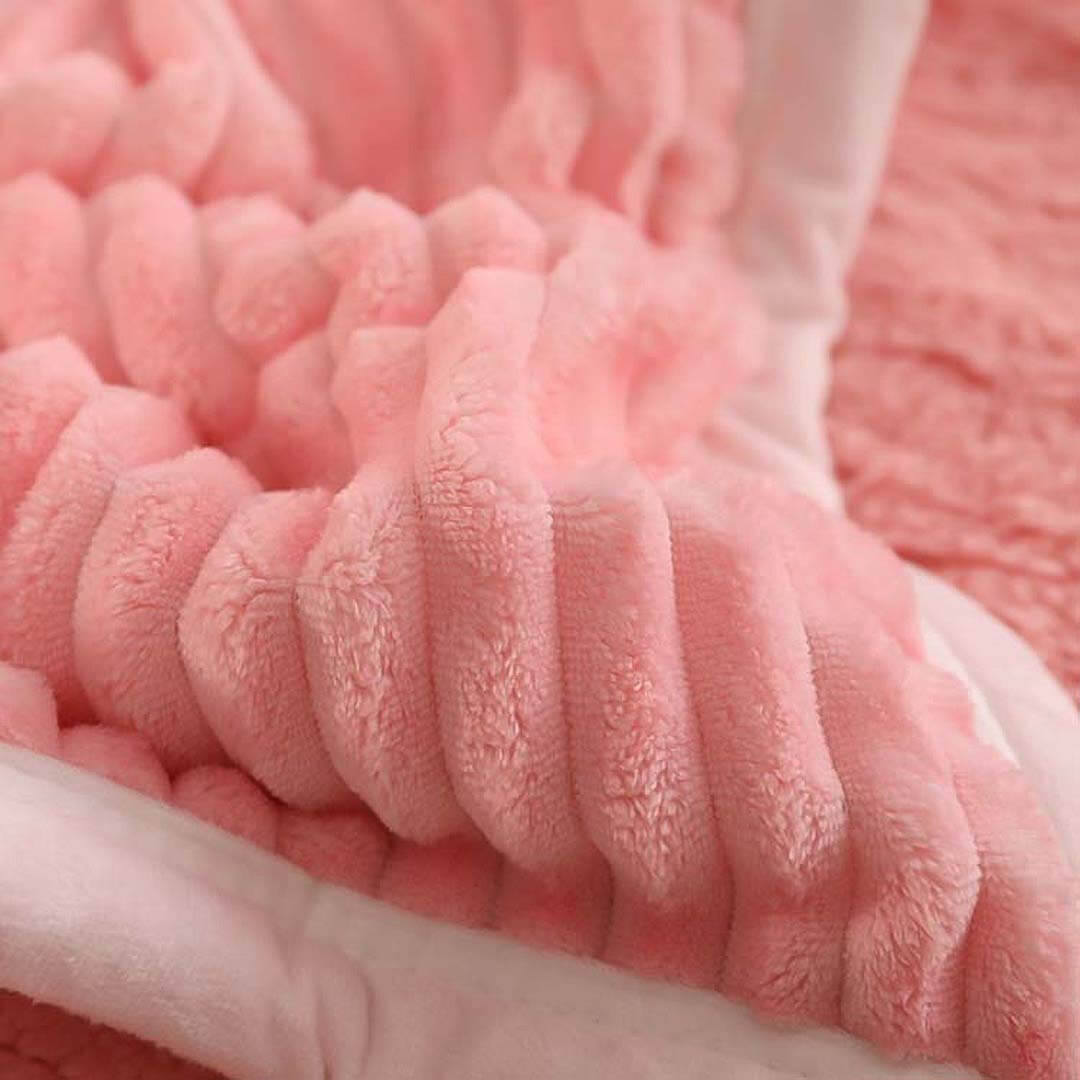 Close-up of a soft, pink, textured blanket showcasing plush fabric from affordable homewares collection featuring quality, value furniture.