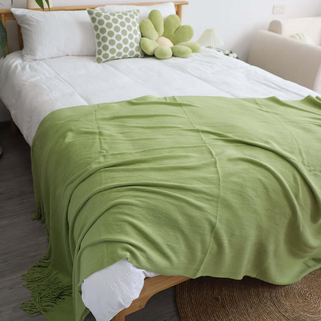 Affordable quality homewares including value furniture with cozy green blanket on a comfortable bed in a stylish bedroom.