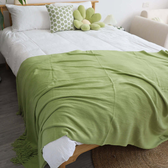 Affordable quality homewares and value furniture, including a cozy green blanket on a stylish bed.