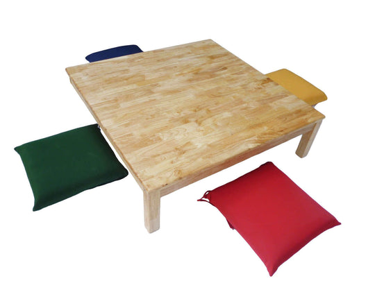 Square low table with four colorful cushions designed for children to play, eat, and create arts and crafts comfortably on the floor.