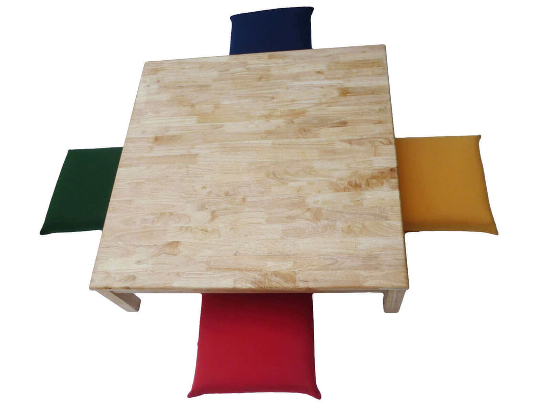 Square low table with four colorful outdoor cushions for kids' play or as a coffee table. Ideal for arts, crafts, and dining.