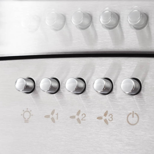 Close-up of stainless steel wall mounted range hood control buttons with fan settings and LED lighting options.