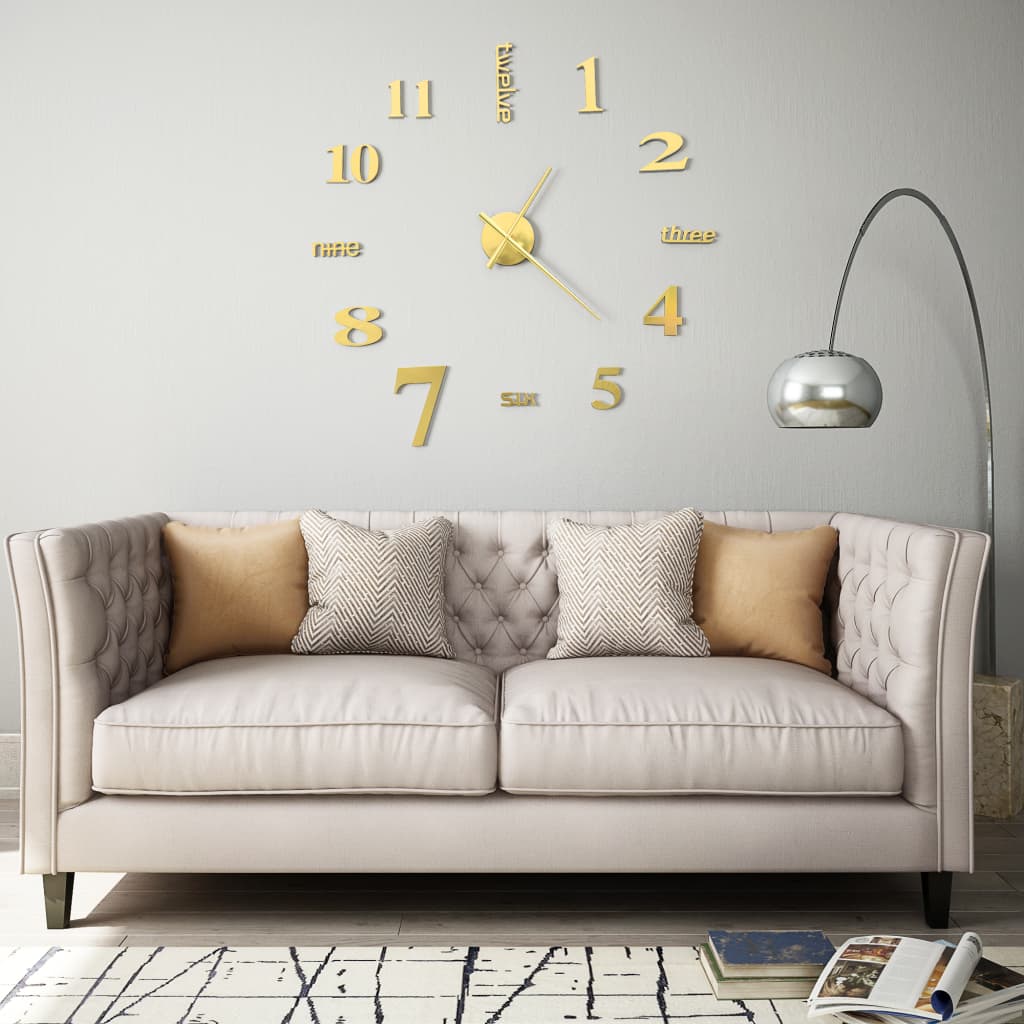 Extra-large 3D wall clock in shiny gold with modern design, mounted above a beige sofa with decorative cushions in a stylish living room.