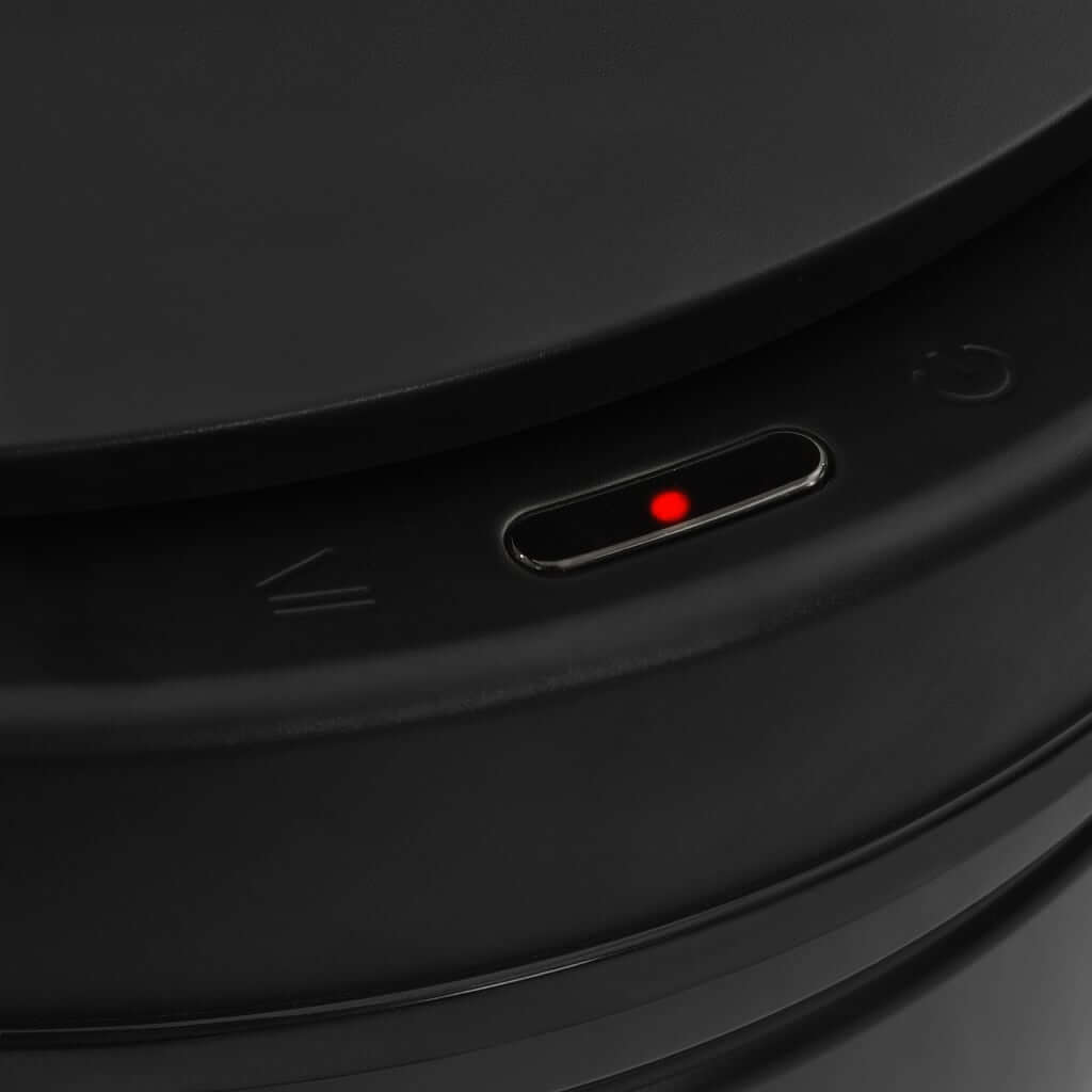 Close-up of automatic sensor on black carbon steel dustbin lid, featuring touchless operation and durable design for affordable luxury.