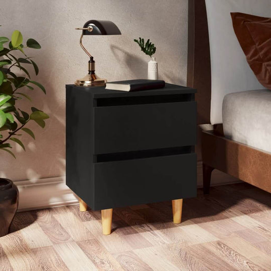 Black bed cabinet with solid pinewood legs and two drawers, offering affordable and quality storage, next to a bed in a cozy room.