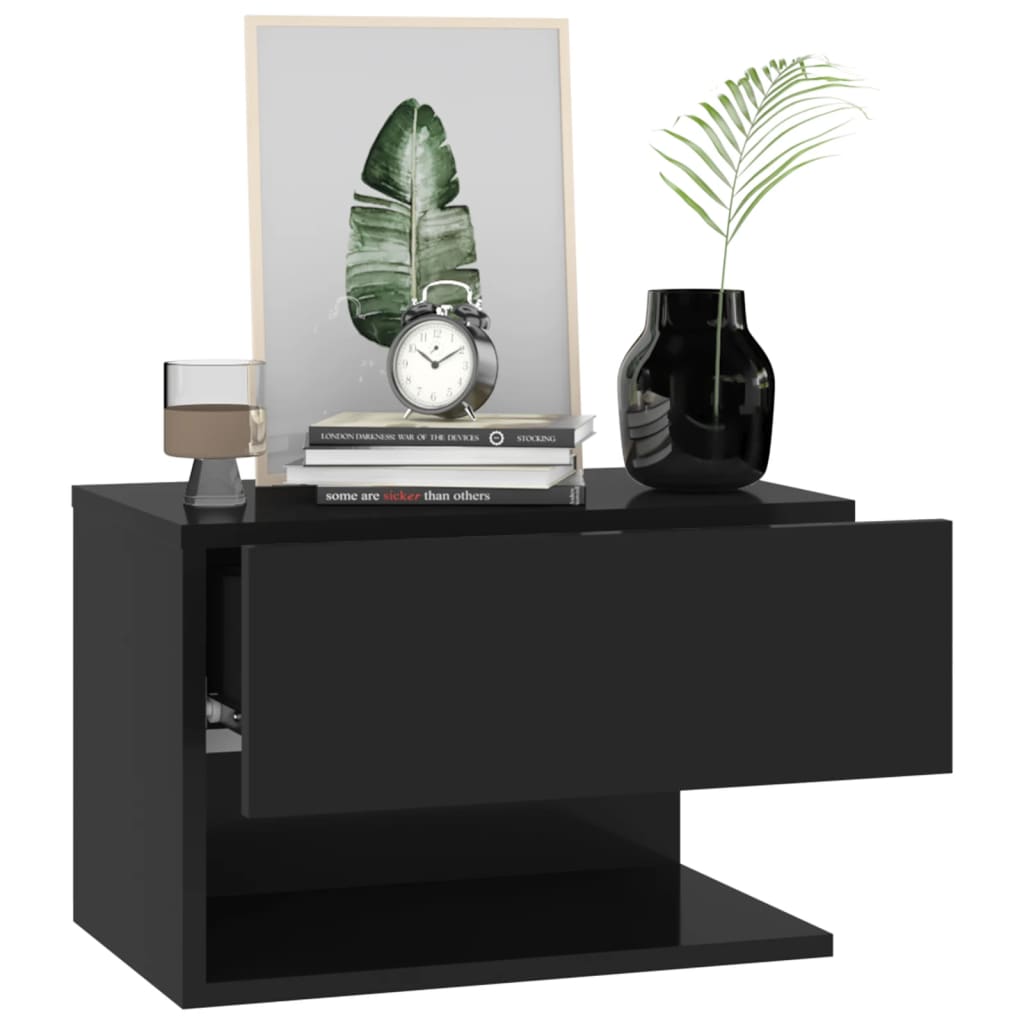 Wall-mounted black bedside cabinet with open drawer, decorated with books, a clock, and a plant, showcasing affordable, quality, and value design.