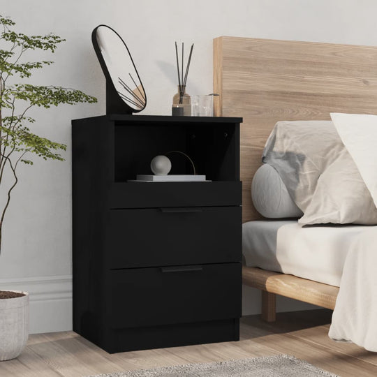 Black engineered wood bedside cabinet with two drawers and one open compartment, shown in a modern bedroom setting.