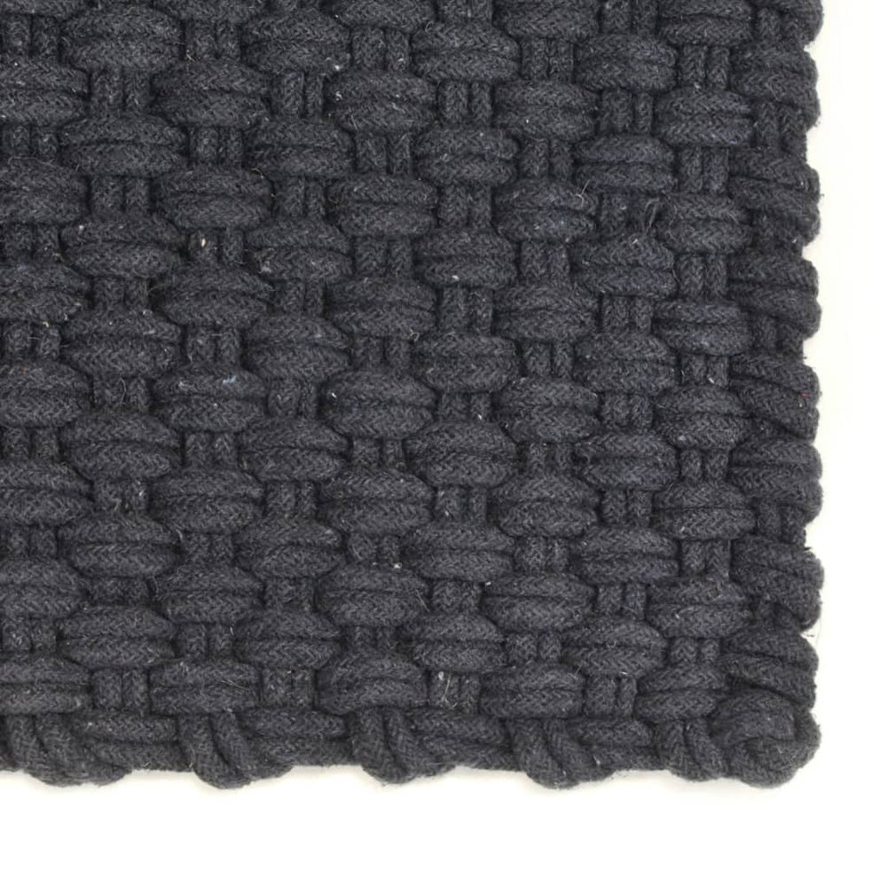 Close-up of anthracite cotton rug with rope-woven texture, showcasing its affordable quality and soft, protective design for home interiors.