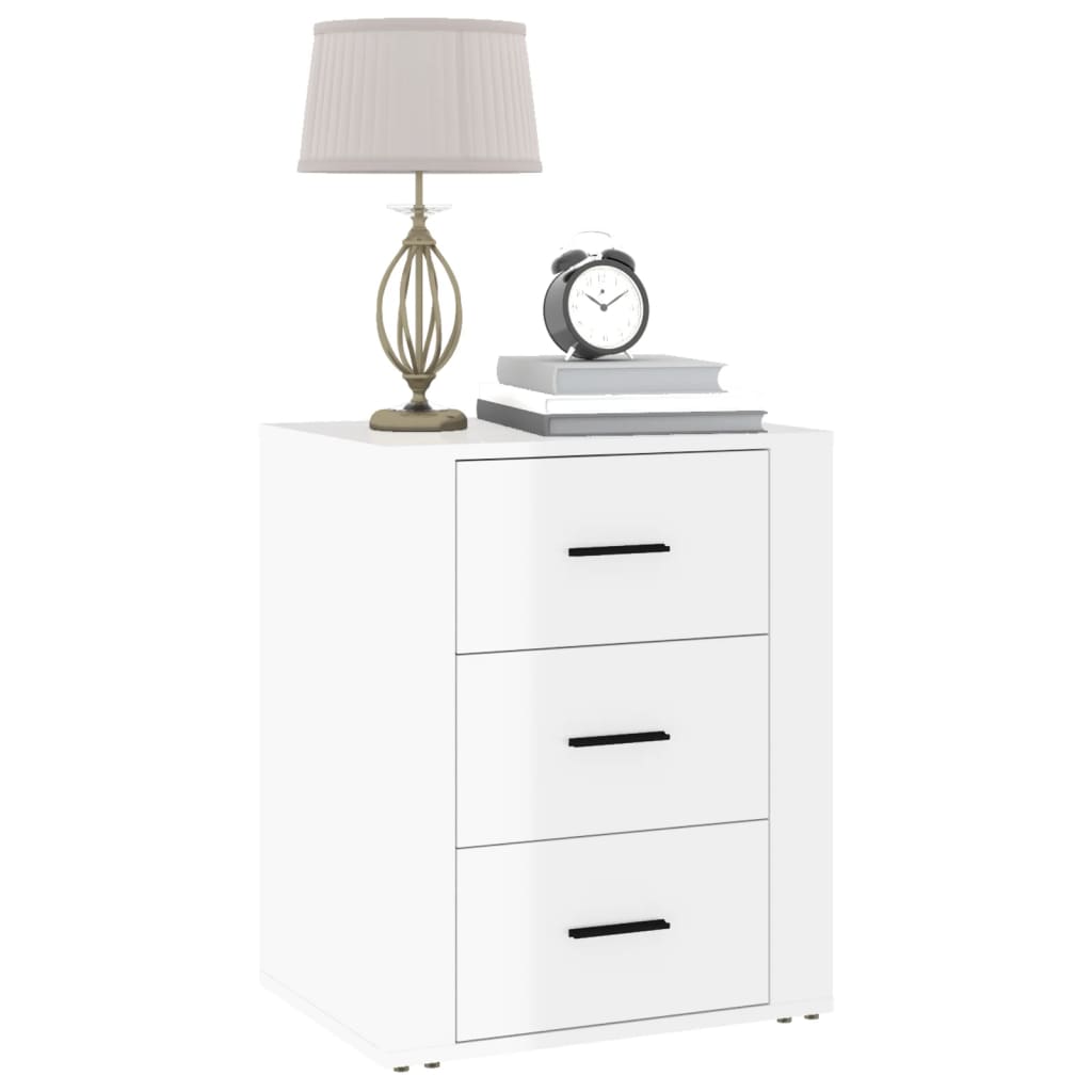 High gloss white bedside cabinet with three drawers, lamp, alarm clock, and books on top, made from quality engineered wood, affordable and durable.