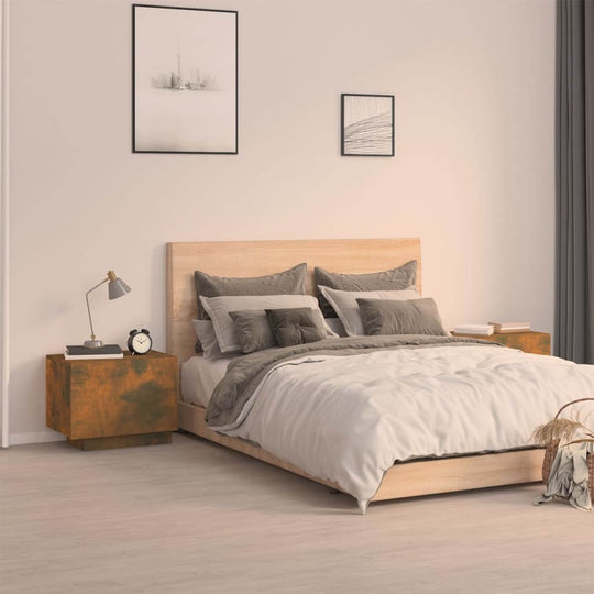 Modern bedroom with affordable quality smoked oak bedside cabinet offering ample storage next to a wooden bed with cozy grey and white bedding.