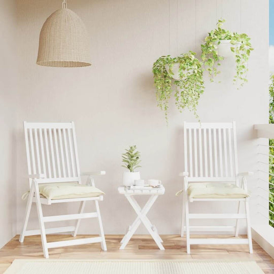 Cream white chair cushions on patio chairs in outdoor setting with greenery and side table, showcasing affordable quality Oxford fabric.