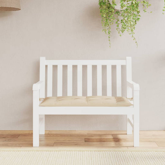 Beige garden bench cushion 100x50x7 cm on white bench, made from durable Oxford fabric. Affordable, high-quality outdoor furniture.