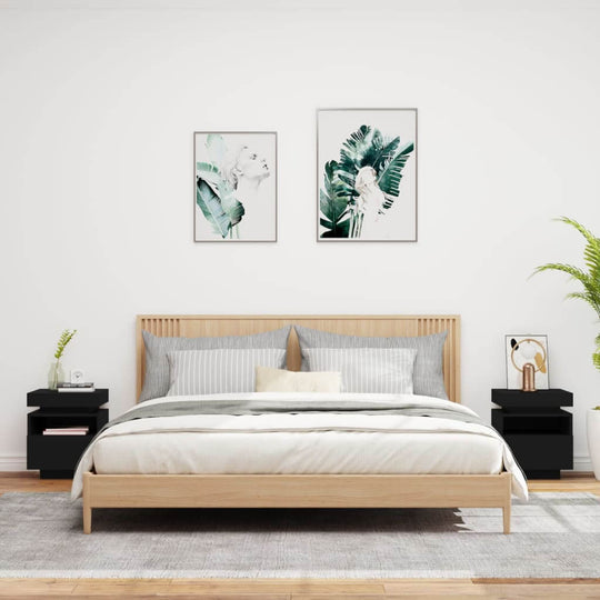 Modern bedroom with wooden bed, black bedside cabinets with LED lights, and green plant artwork on the wall.