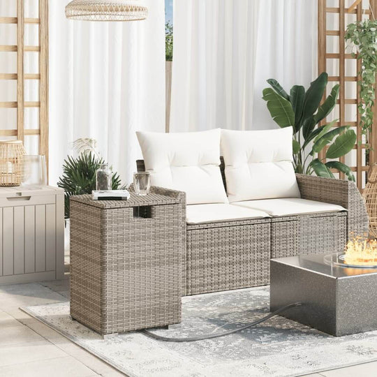 Grey poly rattan propane tank cover table on patio with outdoor sofa and fire pit, showcasing affordable and quality DIY luxe furnishings.