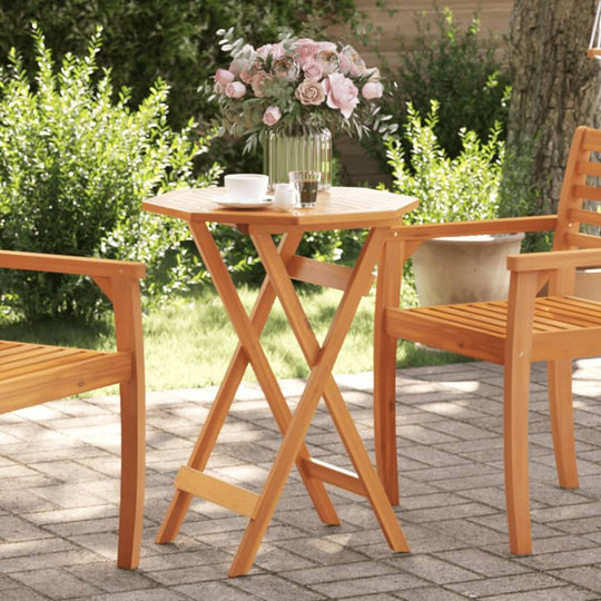 Folding garden table made of solid acacia wood with vase and cups, set on a patio. Affordable, quality, cheap, DIY, luxe furniture.