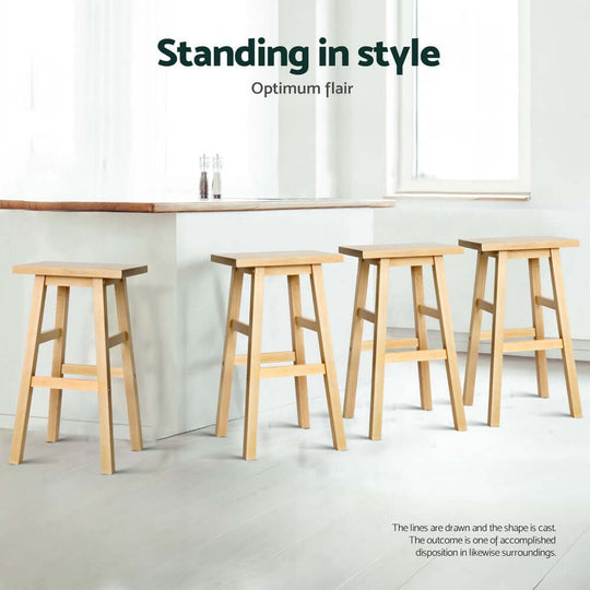 Four wooden bar stools lined up at a kitchen counter, showcasing stylish and sturdy design for affordable home decor.